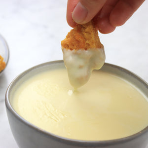 Dipping Tofu Nuggets Into Cheese Sauce Recipe | How To Cuisine